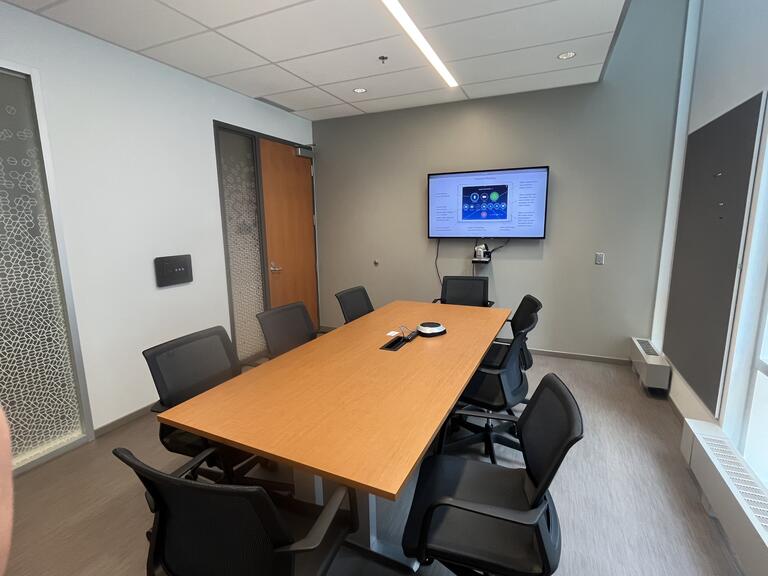 Conference rooms, with a large rectangle table and a big screen TV.