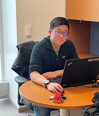 Dr. Matthew Pan sitting at a desk in a Drop In Office.