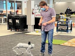 A student walking beside a Robotic Dog Unitree Go 1
