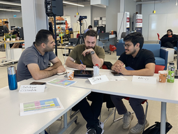 Three students sitting and planning around a table