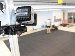 vicon motion capture camera pointing at a black matted floor. 